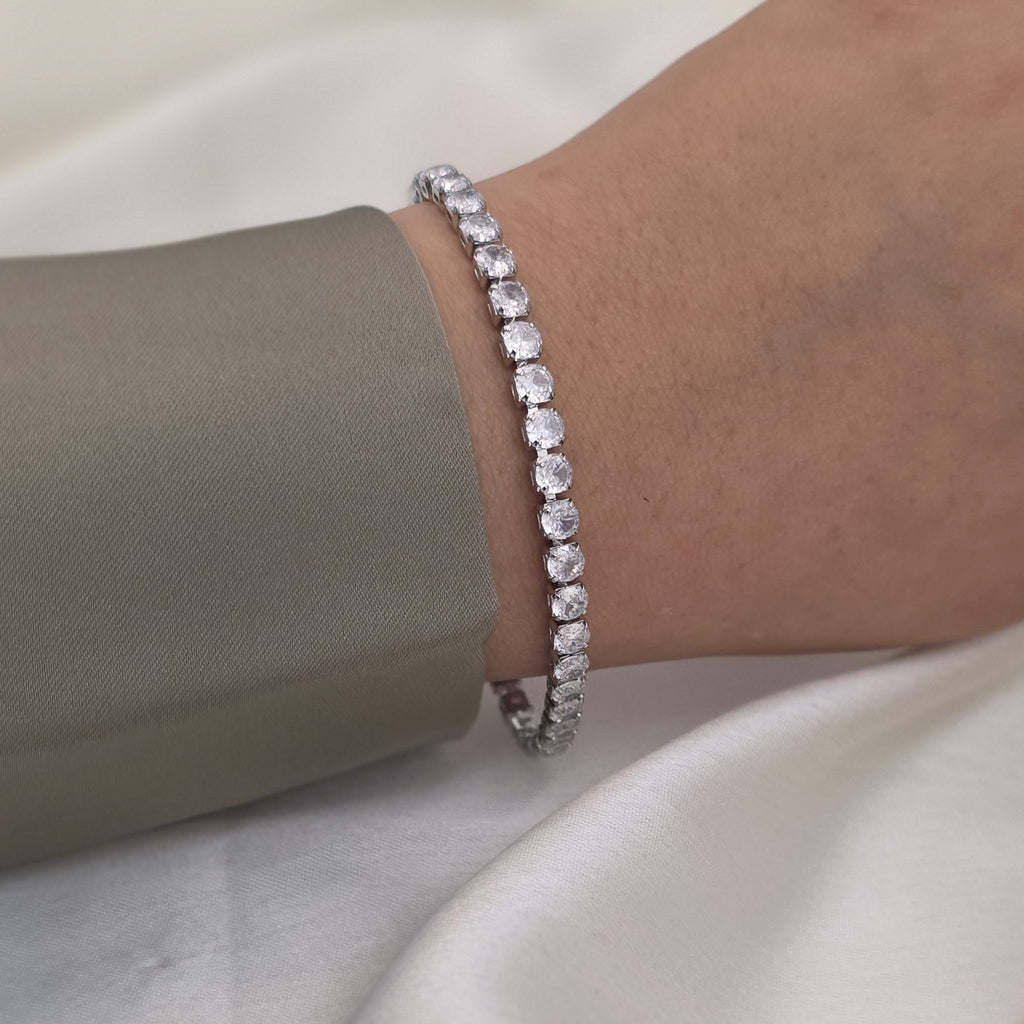 silver tennis bracelet with clear round-cut stones
