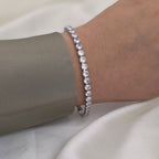 silver tennis bracelet with clear round-cut stones