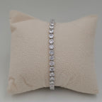 A silver tennis bracelet with round clear stones