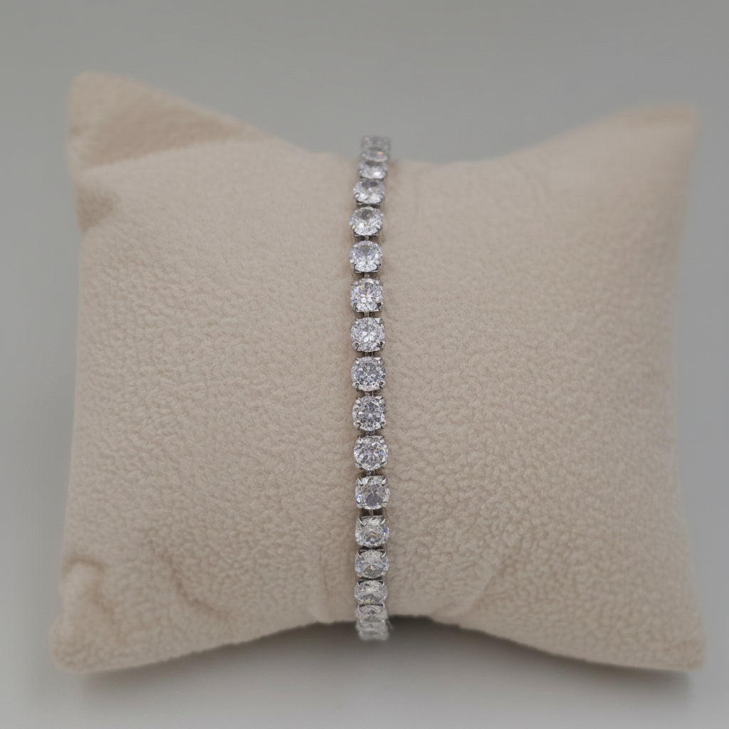 A silver tennis bracelet with round clear stones